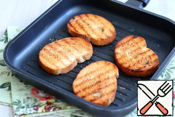 Fry the loaf slices in a toaster or in a dry grill pan until a beautiful golden crust.

