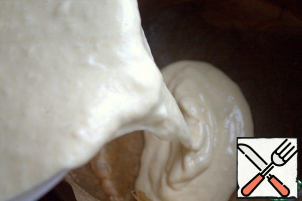 Pour half of the dough into a removable mold on the parchment.
