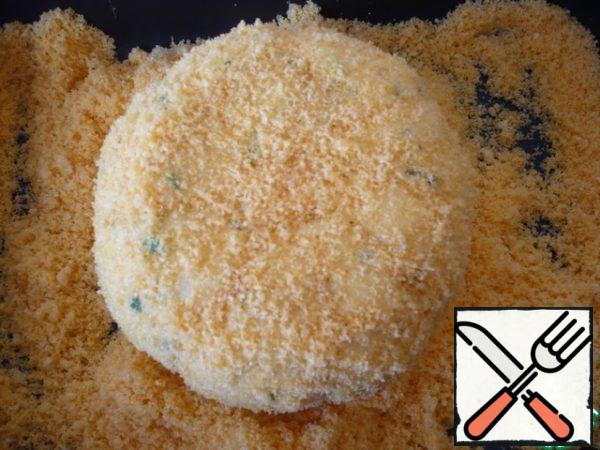 Roll the cheese ball in crushed corn sticks.
