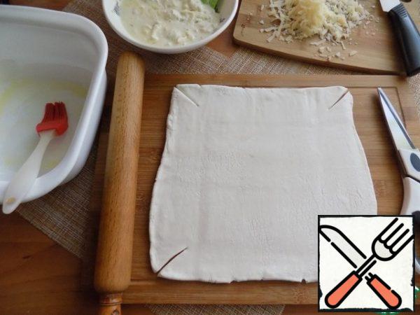 The layer of dough is rolled out according to the size of your shape into a square or rectangle and the sides are allowed to rise by 2.5-3 cm. we Cut the edges, as shown in the photo, to form "sides" at the tart. I have a ceramic form with sides of 20X20 cm. I smeared it with a little oil, so that it is easy to remove the cake.
