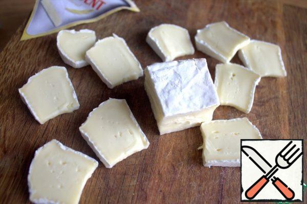 Brie cheese cut into pieces.