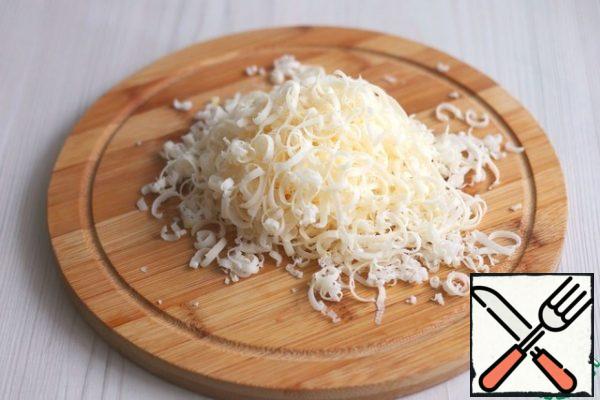 Grate the cheese.
