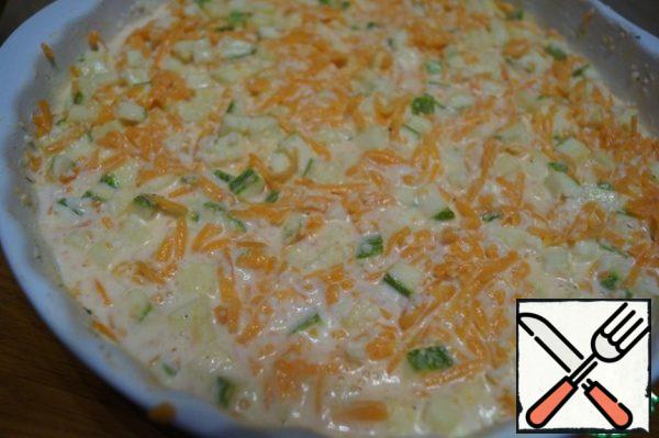 Vegetables mix with egg-sour cream mixture, salt to taste and add spices. Grease a baking dish with butter and pour the mixture there.