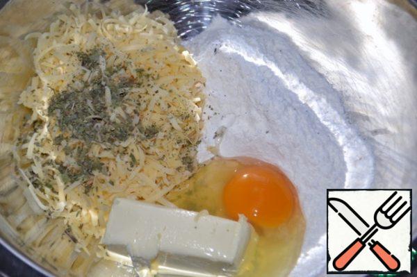 Grate cheese on a fine grater, add butter (room temperature), flour, egg, salt and "Summer greens".