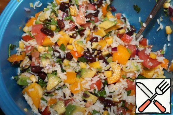 Add vegetables to beans, rice and corn. Pour over the sauce and mix well.