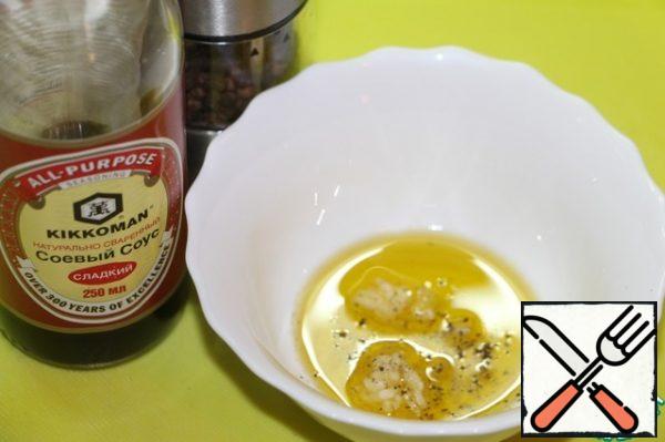 For salad dressing, mix olive oil, crushed garlic clove, sweet soy sauce and freshly ground black pepper.