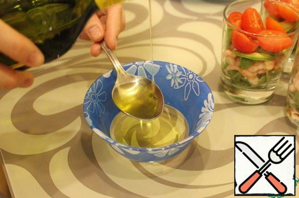 Preparing salad dressing. In a separate bowl, mix the olive oil, ground black pepper.