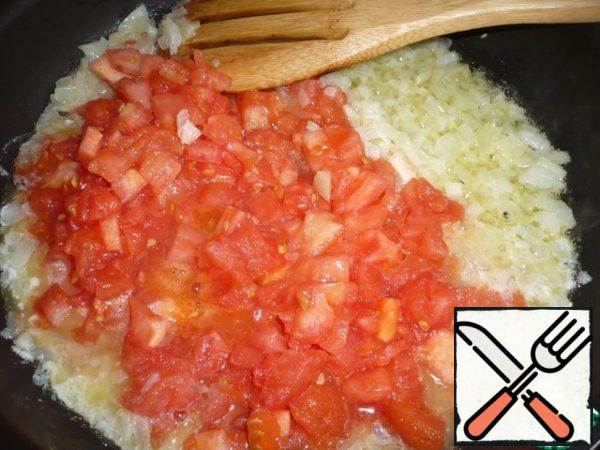 After 2 minutes, add the peeled and finely chopped tomatoes.
