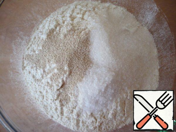 For the dough, mix the sifted flour, with fast-acting yeast, sugar and salt.