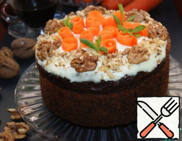 Decorate the top of the cheesecake with nuts and carrot ribbons.