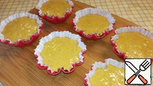 Place paper baking cups in cupcake molds and fill 3/4 full.