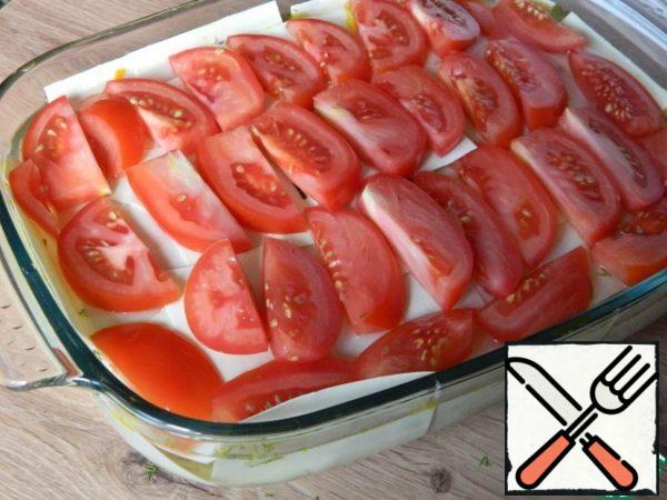 The pasta lay slices chopped tomato.