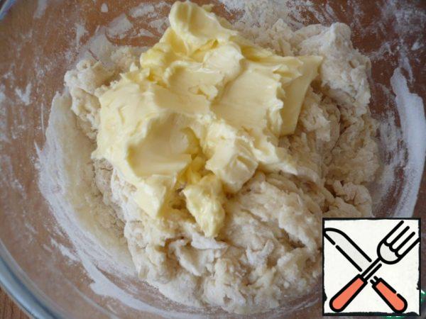 Then add the softened butter. Continue stirring until the dough is moist.