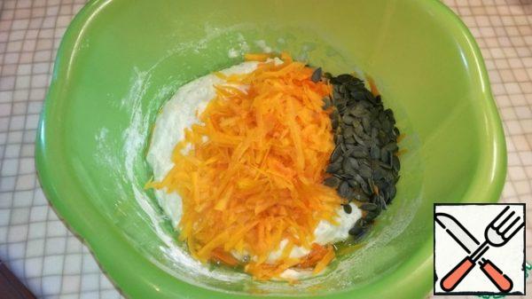 After 15 minutes, add olive oil, grated pumpkin, pumpkin seeds. Mix well.

