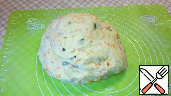 After an hour, knead the dough on a floured surface for 10 minutes. Put it back in a warm place for 30 minutes.
