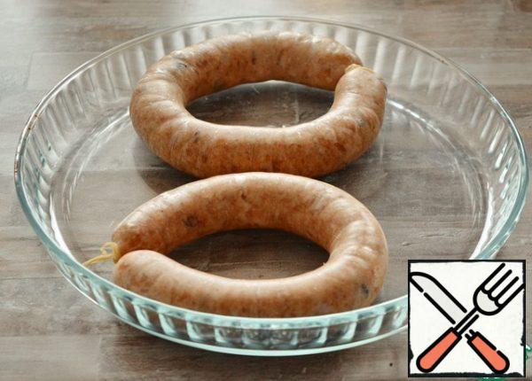 Sausages put it in the fridge for 2-3 hours to shrink. If you see somewhere a bubble of air-pierce this place with a needle and release the air.Then remove the sausage from the refrigerator and hold it at room temperature for an hour and a half