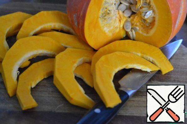 Peel the pumpkin and cut into half moons.