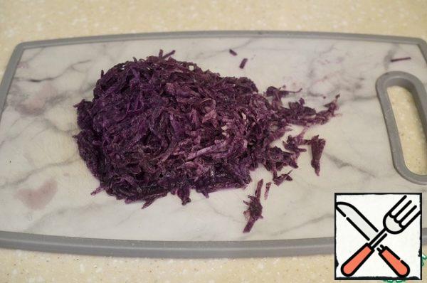 Peel the potatoes and grate. I use purple potatoes.