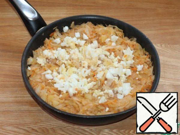 Remove the pan with vegetables from the stove and add finely chopped boiled chicken eggs.
