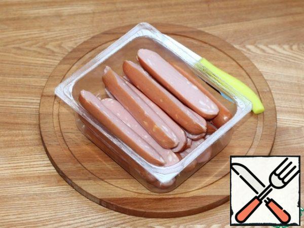 Cut each sausage in half.