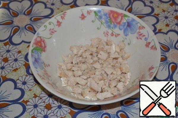 Boil the chicken breast in salted water. Cool and cut into small cubes.
