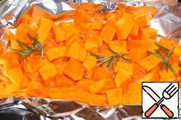 Place the pumpkin in foil and add a couple of sprigs of rosemary. Bake in a preheated 200 " C oven for 15-20 minutes.