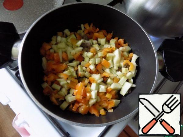Spread the carrots, cut into small cubes. Cover with a lid and simmer for 5 minutes on medium heat. Next-small pieces of zucchini and bell pepper. Again we languish for 5 minutes. We don't need to make vegetables boiled. In this soup they should be in a state of al dente (to the tooth).