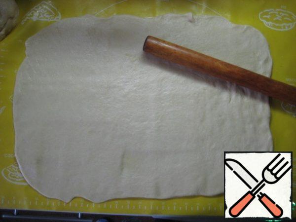Roll out each part into a rectangular layer (I did it on a sheet of parchment and a cooking Mat).