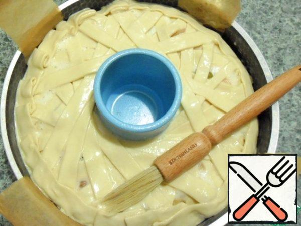 Lay out ribbons of dough on fruit in the form of an arbitrary lattice.
Lubricate the upper hand remnants of egg a mixture.
Send in a preheated 220 degree oven.
Bake for 15 minutes, reduce t to 180, bake until tender, my oven took another 20 minutes.