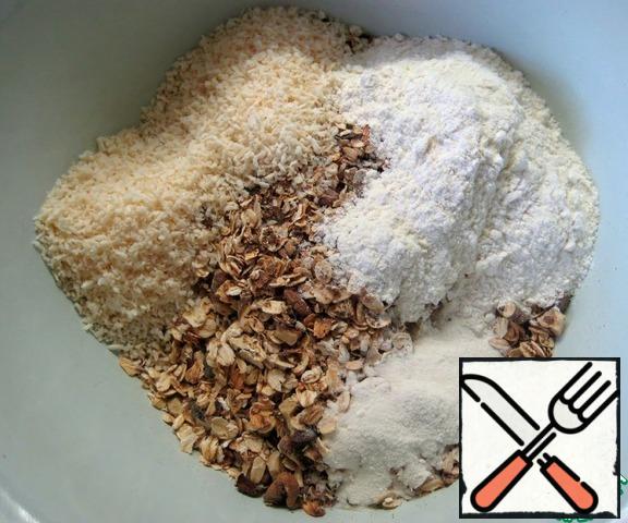 In a bowl, combine the flour, oatmeal, walnuts, coconut, baking powder, salt. Stir.