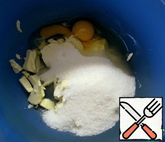 In a separate bowl, beat the eggs, sugar and pieces of soft butter.