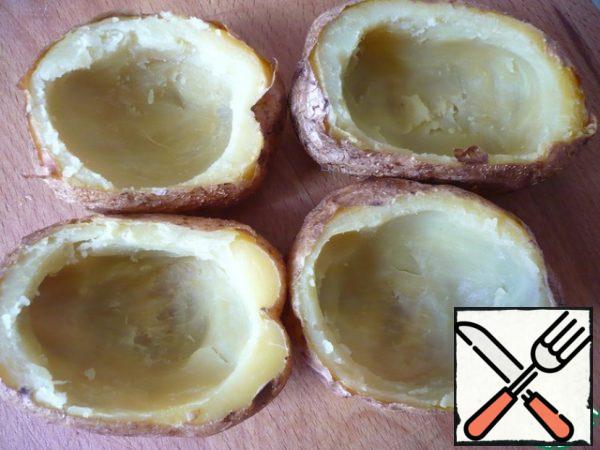 Gently scrape the flesh from the potatoes into a bowl with a teaspoon.