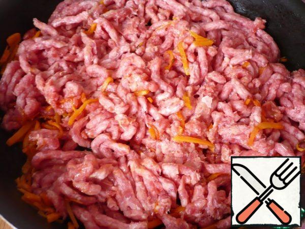 Add the ground beef and cook, breaking the pieces with a wooden spoon, for about 4 minutes, until it is browned.