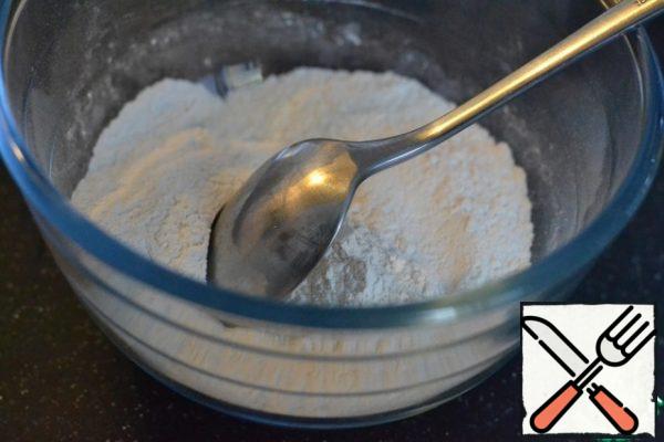 Beat the eggs with sugar with a mixer.
Gradually add flour and baking powder. Beat with a mixer on medium speed.
