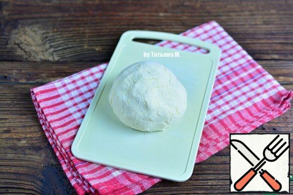 Add water, knead not sticky dough, put in a bag and in the refrigerator for 30 minutes.