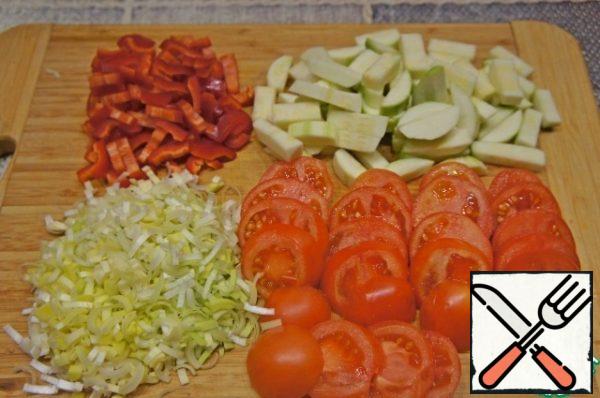 Cut zucchini into cubes, bell pepper into strips, tomatoes into 0.5-1 cm thick circles. Disassemble the cabbage into small inflorescences. Cut the potatoes arbitrarily. Crush the garlic.
