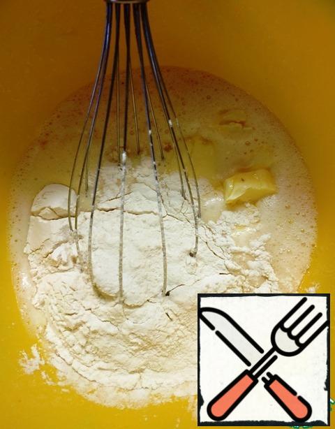 To the egg-sugar mixture, add pieces of soft butter and flour. Mix thoroughly until smooth.