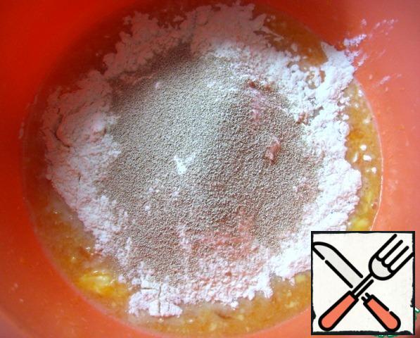 Add salt, sugar, half the necessary flour and yeast. Start kneading the dough.