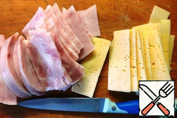 For the filling, cut thin slices of ham and cheese.