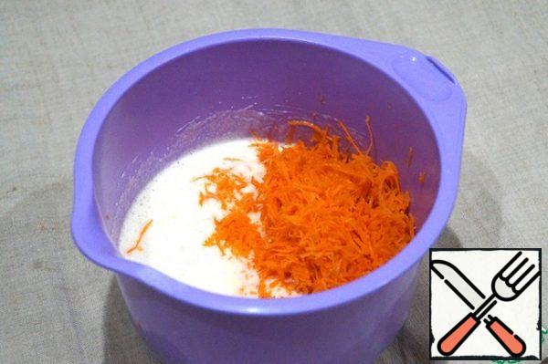 In the egg mixture, pour the tea, vegetable oil, add grated carrots, stir.