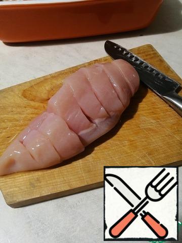 Wash chicken fillet, make cuts almost completely cutting.