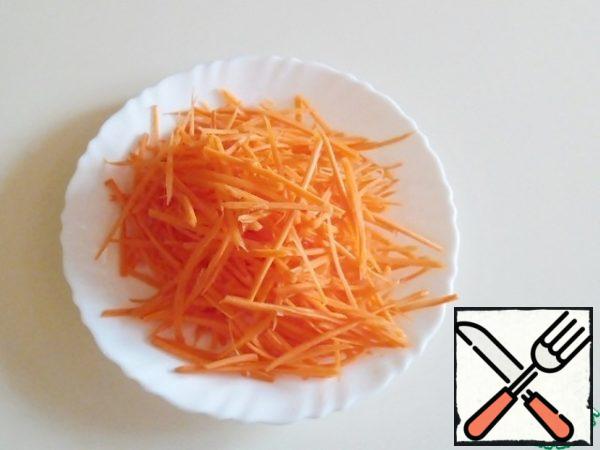 Grate carrots into strips.