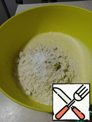 Add flour and baking powder and mix with a mixer.