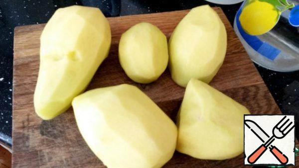 Peel potatoes, cut in half.