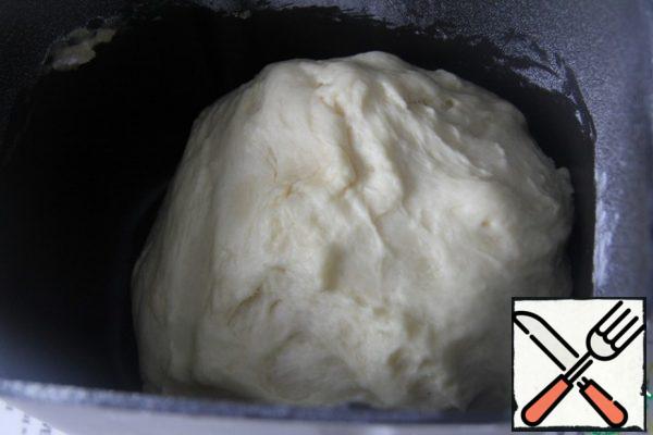 To prepare the dough, you can use a bread maker. Or knead with your hands, mixing all the ingredients (without oil), and then pour the oil into the dough and leave for proofing in a warm place (to increase in volume by 2-2. 5 times)

