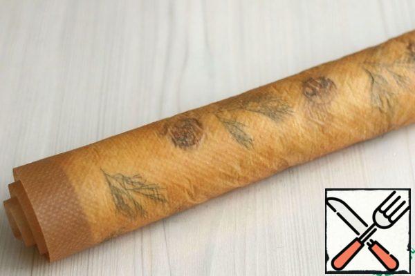 Roll the roll together with the parchment side up and leave to cool. It will take quite a bit of time.
