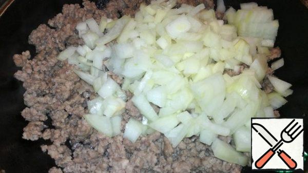 Onions and garlic cut into small cubes and send to the stuffing. Fry for 2 minutes.