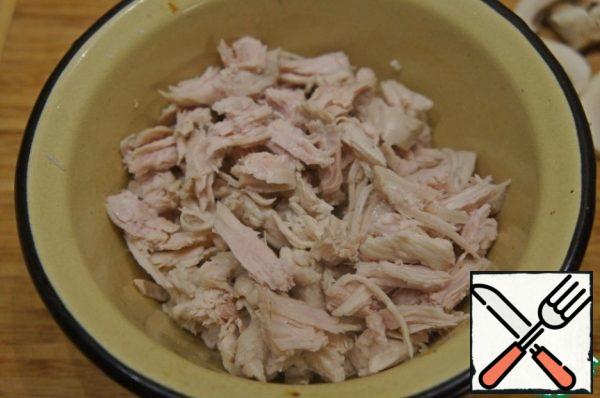 Boil the breast until tender, disassemble into pieces.