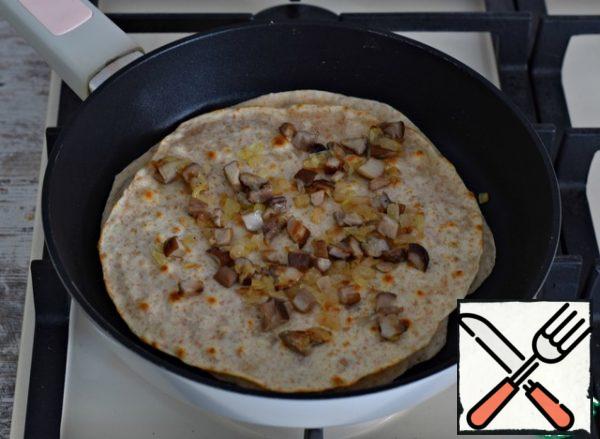 Again, put the filling, cover with the next tortilla, press down, turn over and so on. To turn over a stack with tortillas it is better a wide shovel or two small.