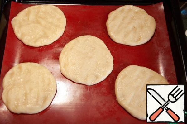 Divide the dough into 7 equal parts, roll into tight balls, cover with cling film and leave for 10 minutes. Roll out into neat tortillas about 5 mm thick. You can roll out the dough into a layer and cut into squares with a side of 5-7 cm. Spread the blanks on paper-lined baking sheets, cover with a film and leave for 45-60 minutes at room temperature.
